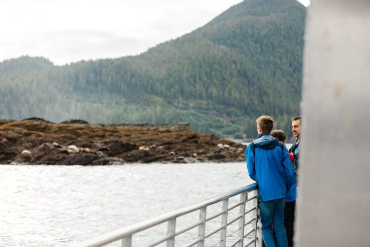 a person standing next to a body of water