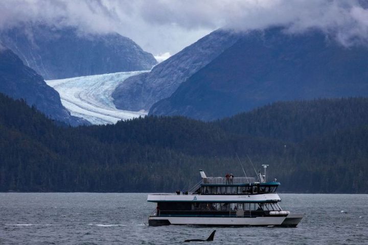 a small boat in a body of water with a mountain in the background