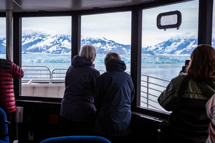a couple of people that are standing in front of a window