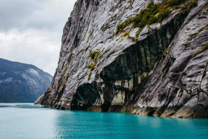 a body of water with a mountain in the background