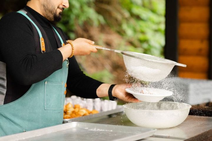 a person standing next to a bowl of food
