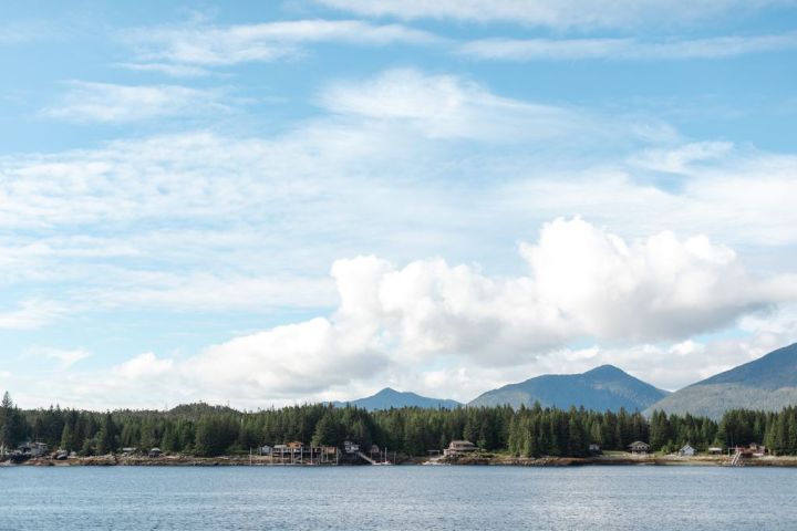 a body of water with a mountain in the background