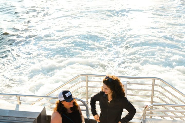 a person standing next to a body of water