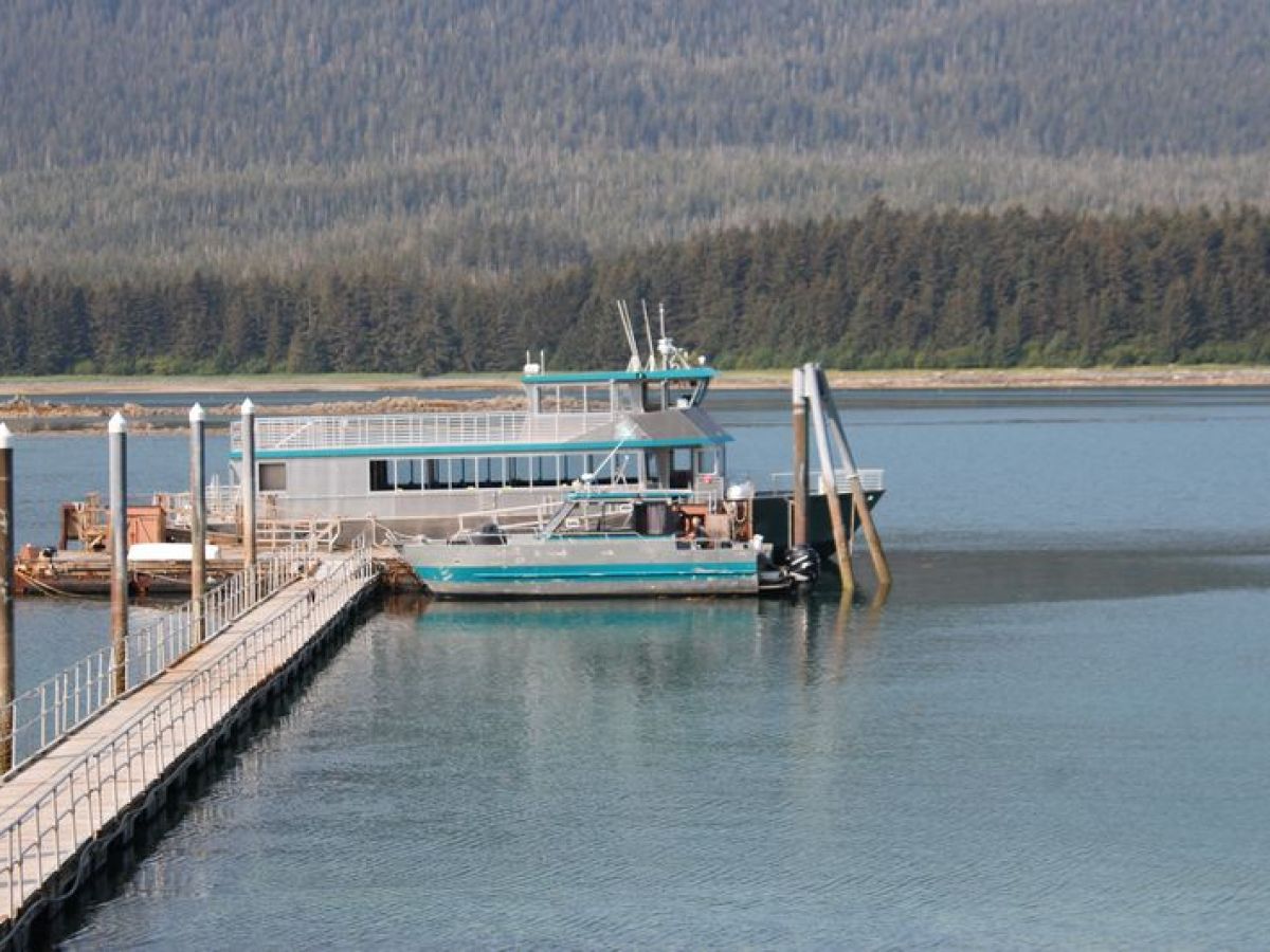 a boat is docked next to a body of water