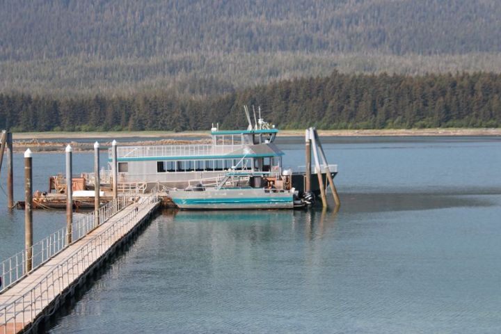 a boat is docked next to a body of water