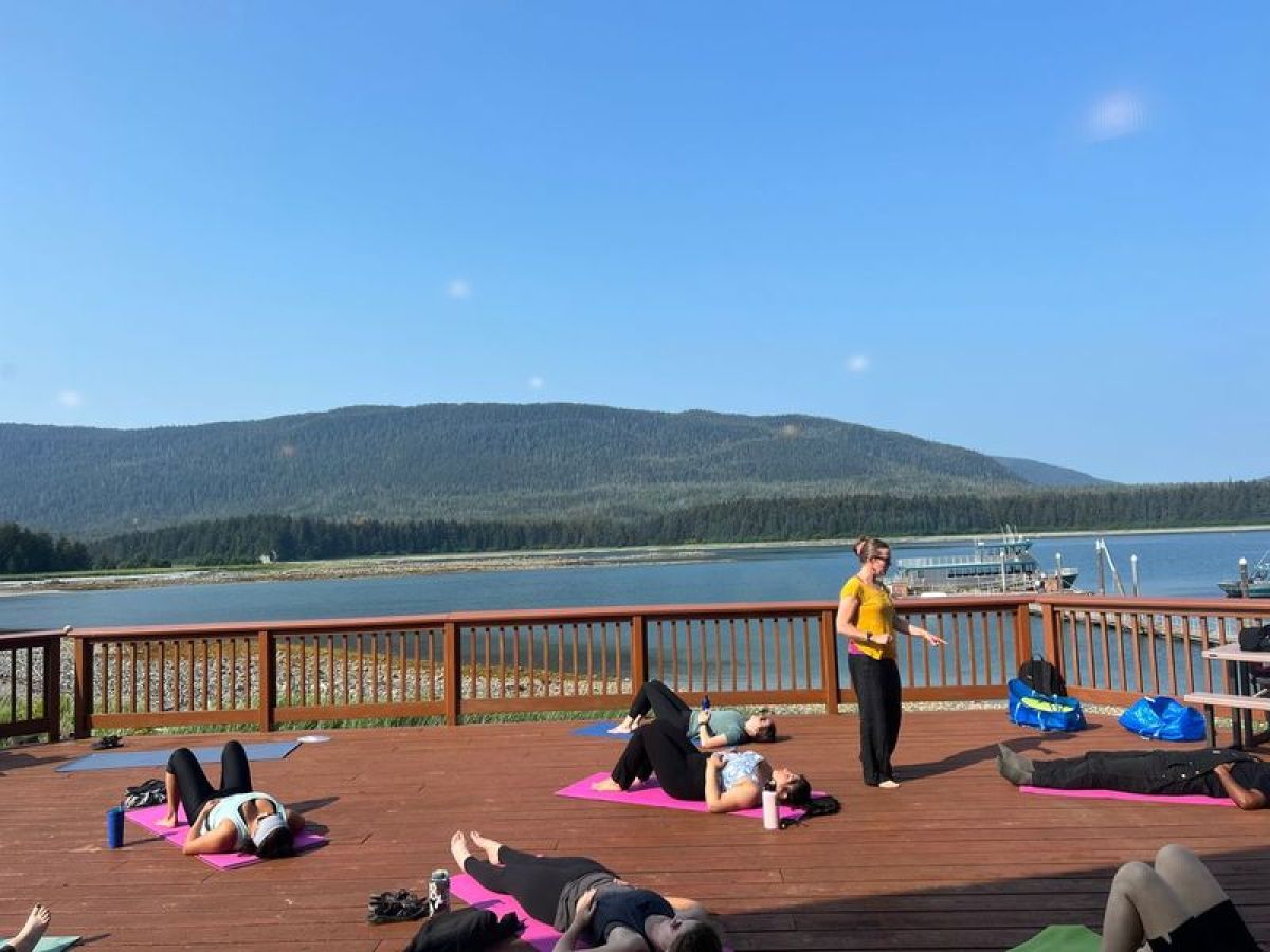 a group of people sitting at a beach