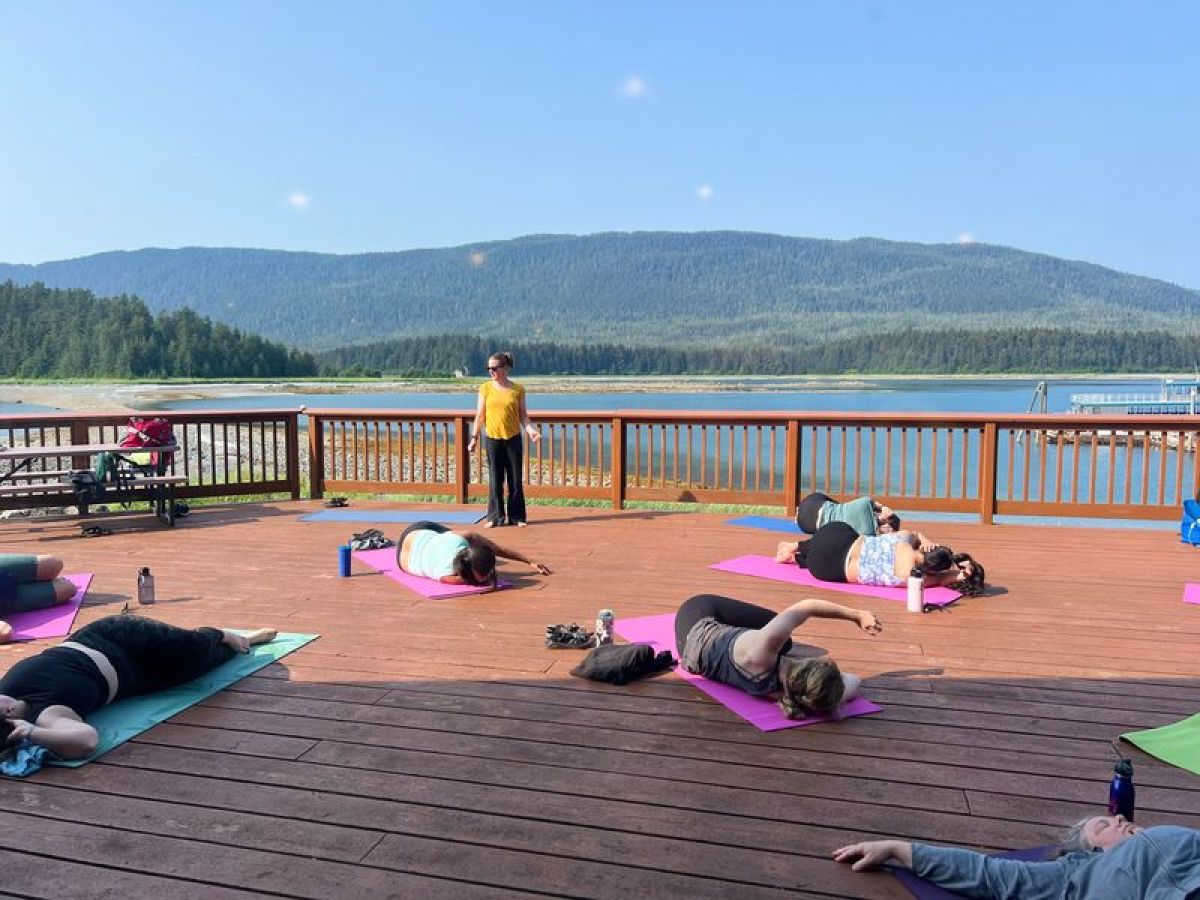a group of people sitting at a beach