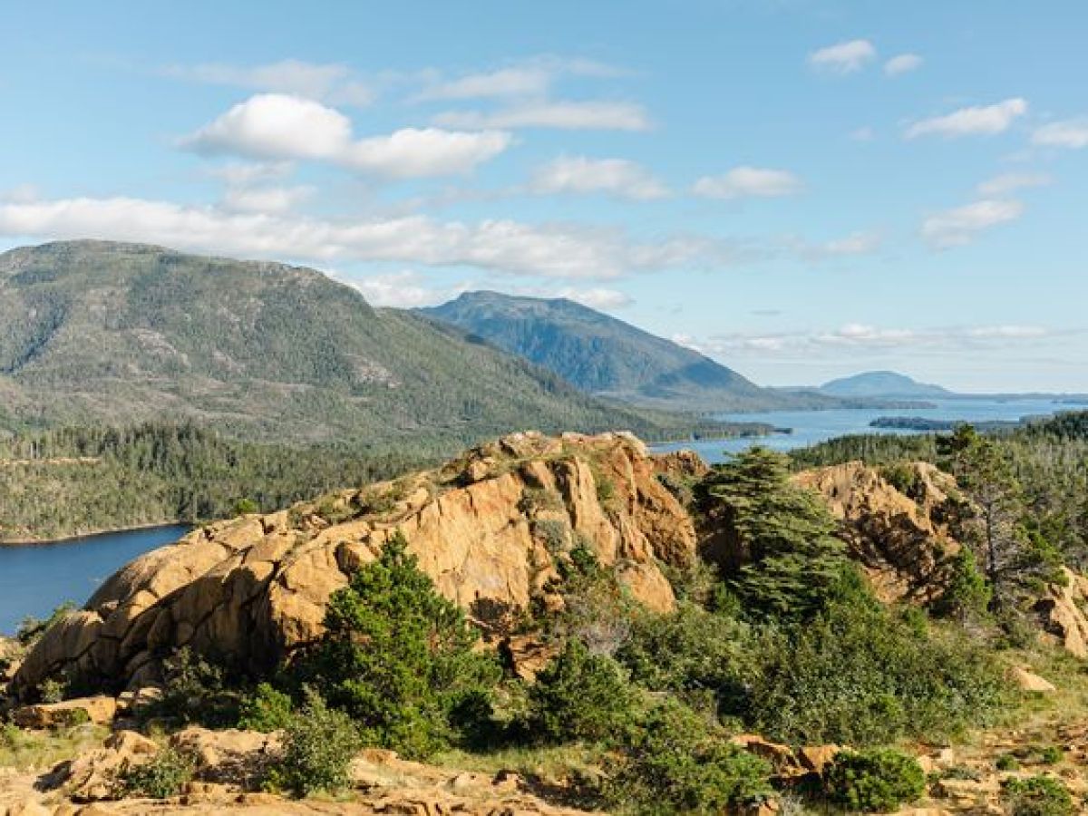 a body of water with a mountain in the background