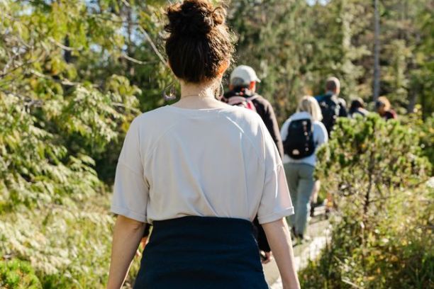 a couple of people that are standing in the grass