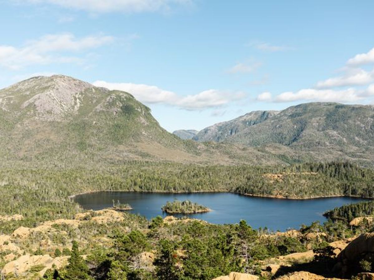 a body of water with a mountain in the background