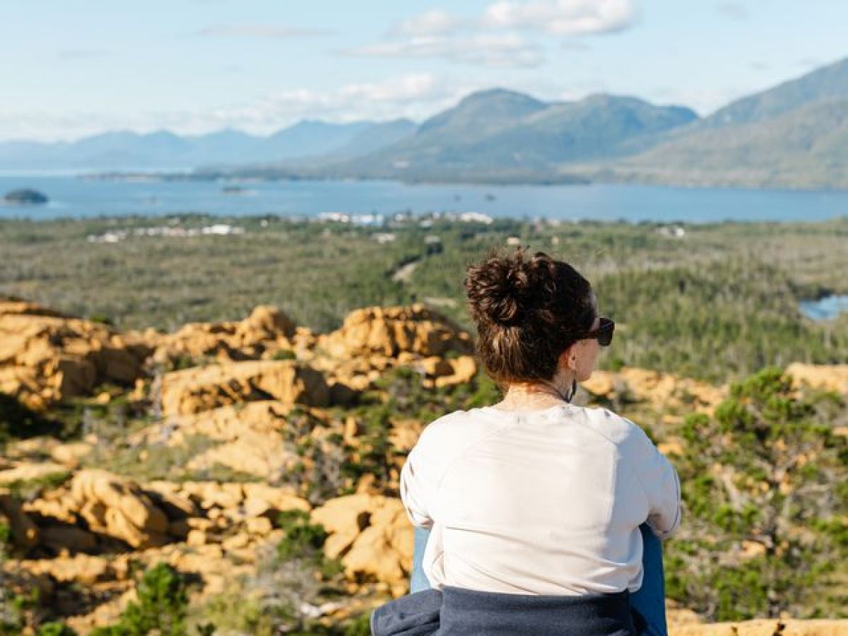 a person sitting on a rock