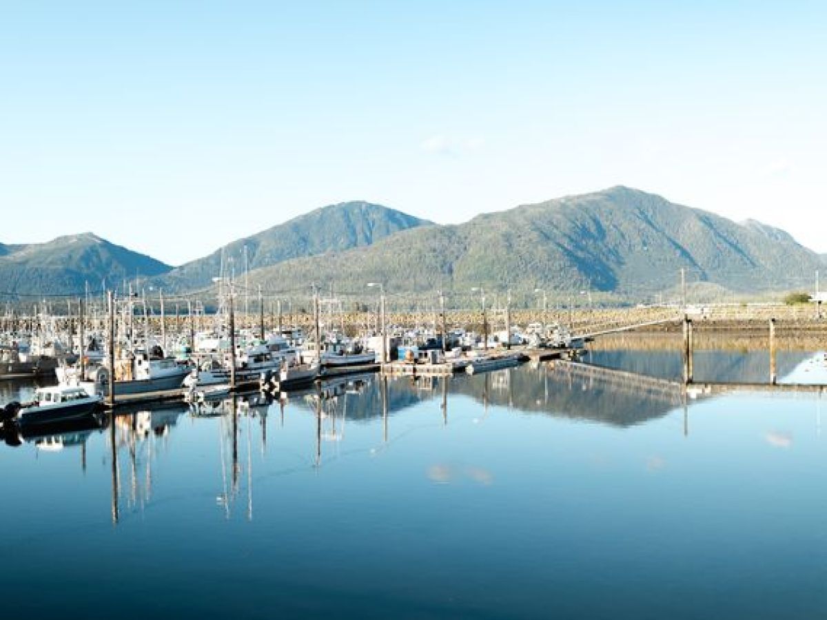 a boat is docked next to a body of water