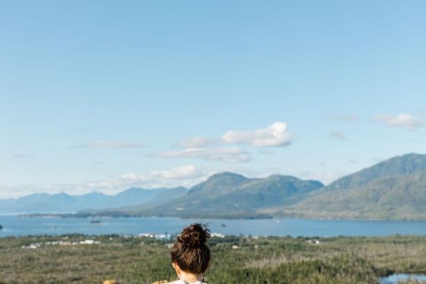 a person sitting on a bench with a mountain in the background
