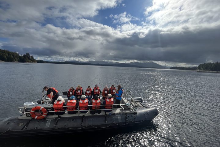 a group of people in a boat on a body of water